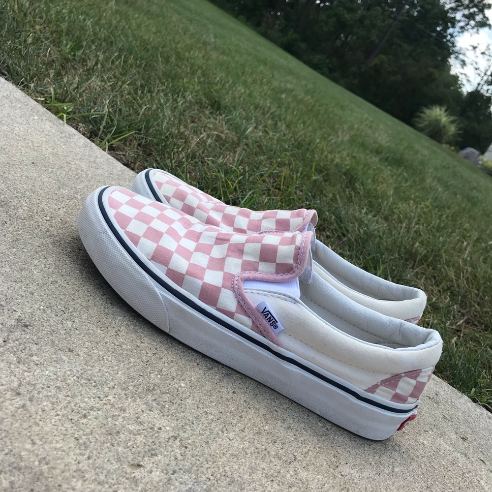 Pink and off white checkered slip on vans.